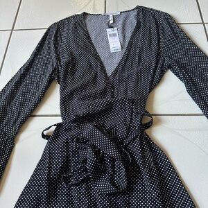 Black and white polka dot mini dress with bell sleeves and tie waist